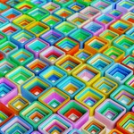 Vibrant 3D abstract composition with multicolored geometric shapes in a repeating pattern.